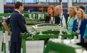 El presidente de la Junta de Andalucía, Juanma Moreno, durante la inauguración de Pilatus Aircraft Ibérica, junto a la dirigente de la planta, Victoria Vallecillos.