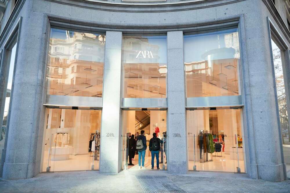 Vista del exterior de la tienda de Zara en Plaza España en Madrid en la que aparecen personas a la entrada de la tienda