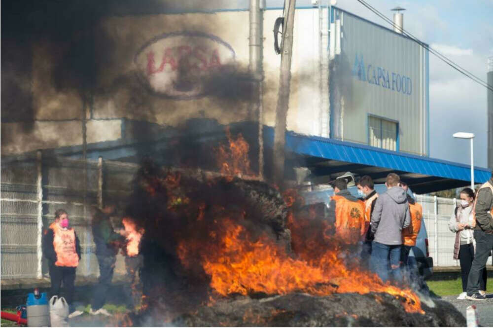 Una hoguera durante una acción sindical ante la planta de Larsa para exigir unos «precios justos» para la producción de leche, a 16 de noviembre de 2021, en Robra, Outeiro de Rei, Lugo, Galicia, (España). Apoyados por el sindicato Unións Agrarias (UU.AA), – Carlos Castro – Europa Press