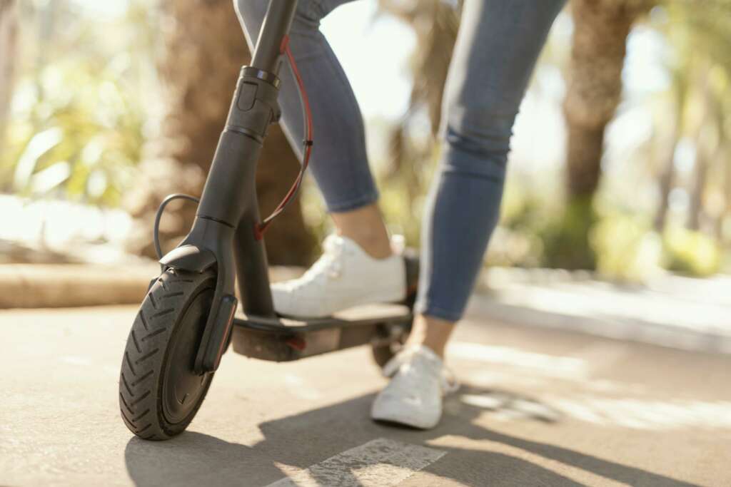 Una mujer conduce un patinete. Foto: freepik.