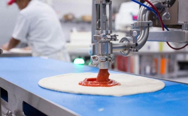 pizza crust slides down conveyor belt and lands under one two sauce dispensers named giorgio and pepe they release different amounts sauce based customers order
