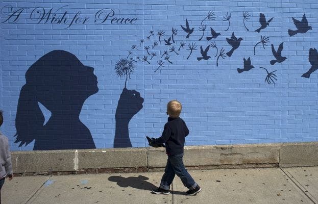 Un niño mira un mural por la paz en Medford, Massachusetts
