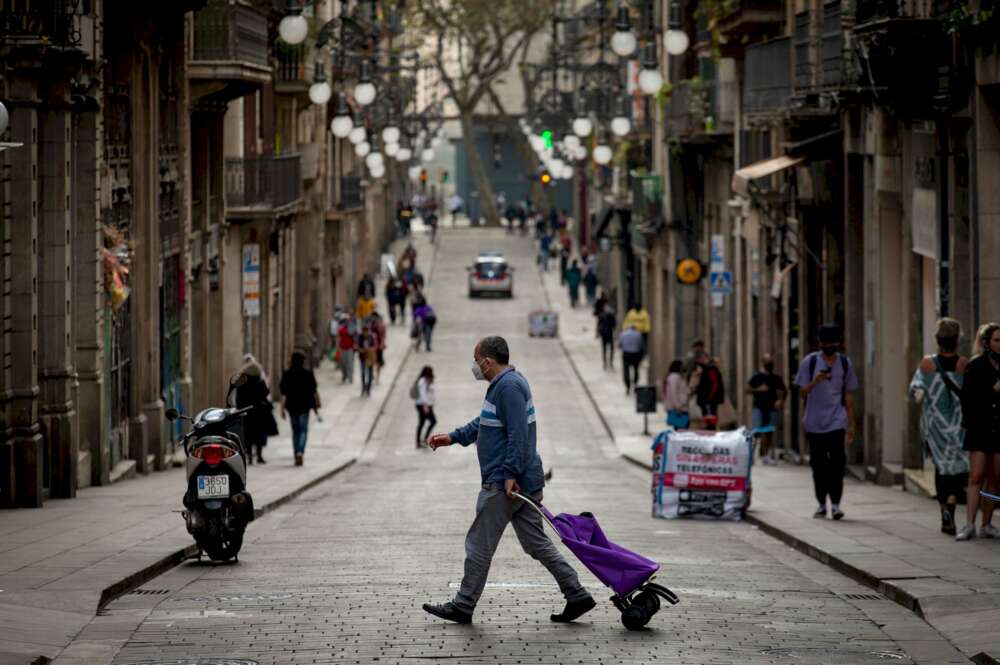 Un vecino de Barcelona se dirige a realizar sus compras por el centro de la ciudad, en plena pandemia de coronavirus | EFE/Enric Fontcuberta/Archivo