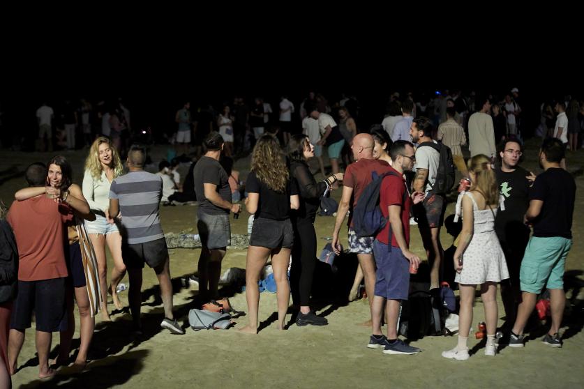 Ambiente hoy viernes en la playa de la Barceloneta en la noche que entra el toque de queda nocturno desde la 1 de la madrugada hasta las 6 de la mañana, en los 161 municipios afectados por esta nueva restricción que ha autorizado el Tribunal Superior de Justicia de Cataluña (TSJC) hasta el 23 de julio. EFE/Alejandro García.ALEJANDRO GARCÍA / EFE