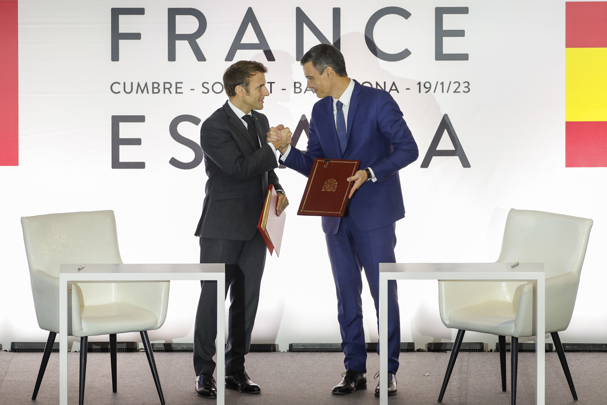 El presidente del Gobierno, Pedro Sánchez (d), estrecha la mano al presidente francés, Emmanuel Macron, durante la ceremonia de firma de acuerdos celebrada en el marco de la Cumbre Hispanofrancesa, este jueves, en Barcelona. EFE/Alberto Estévez