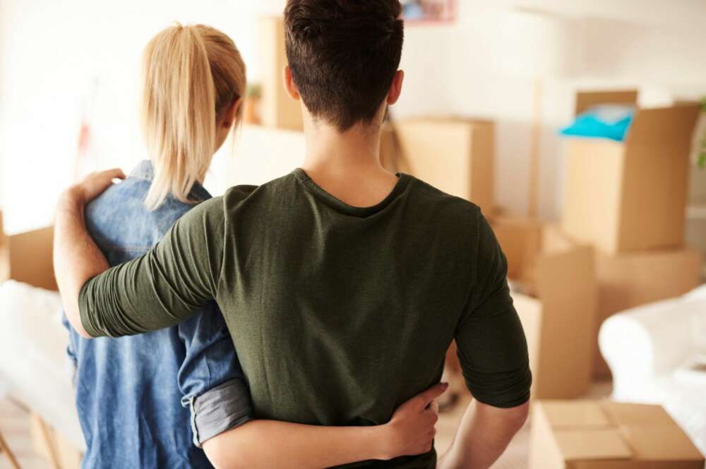 Una pareja se abraza mientras mira las cajas de una mudanza. alquiler. Foto: Freepik.