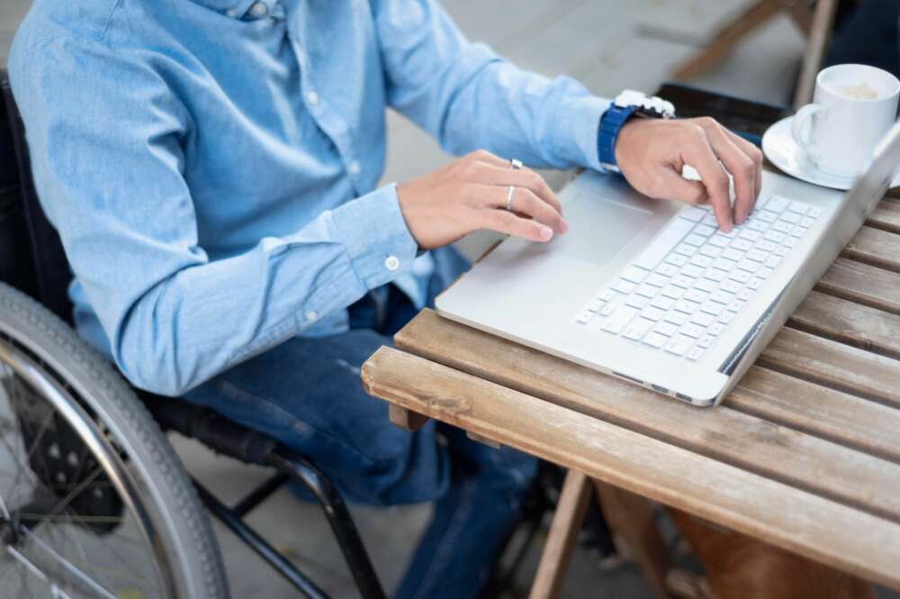 Un hombre con discapacidad utiliza su ordenador. Foto: Freepik.