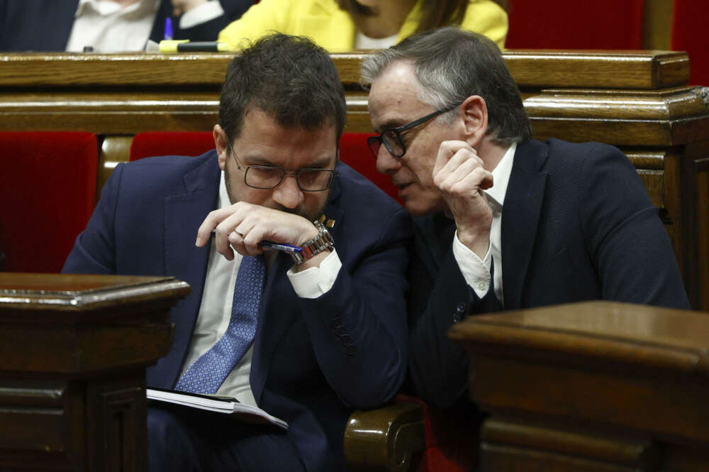 GRAFCAT1260. BARCELONA, 13/03/2024.- El presidente de la Generalitat, Pere Aragonès (i), conversa con el portavoz de ERC, Josep Maria Jové (d), durante el debate de totalidad de los presupuestos de la Generalitat para 2024 en el Parlamento de Cataluña, que se celebra sin que de momento el presidente Aragonès haya podido atar el apoyo de los comunes a las cuentas. EFE/Quique García