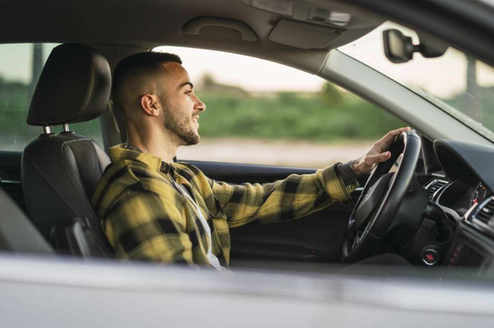 Un conductor al frente del volante. Foto: Freepik.