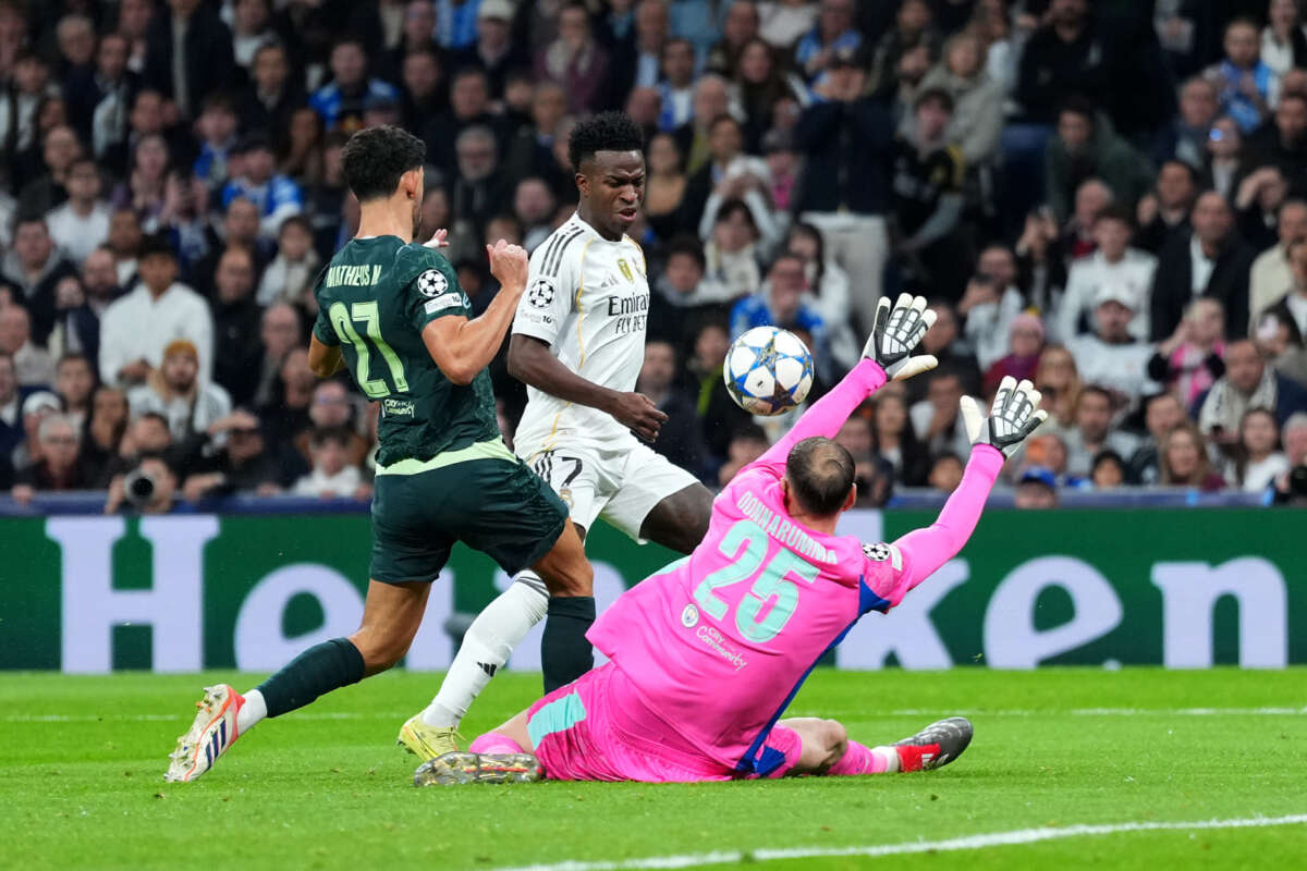 MADRID, SPAIN - DECEMBER 10: Vinicius Junior of Real Madrid misses a chance as he is challenged by Matheus Nunes and Gianluigi Donnarumma of Manchester City during the UEFA Champions League 2025/26 League Phase MD6 match between Real Madrid C.F. and Manchester City at Estadio Santiago Bernabeu on December 10, 2025 in Madrid, Spain. (Photo by Angel Martinez - UEFA/UEFA via Getty Images)