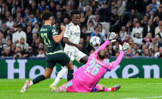 MADRID, SPAIN - DECEMBER 10: Vinicius Junior of Real Madrid misses a chance as he is challenged by Matheus Nunes and Gianluigi Donnarumma of Manchester City during the UEFA Champions League 2025/26 League Phase MD6 match between Real Madrid C.F. and Manchester City at Estadio Santiago Bernabeu on December 10, 2025 in Madrid, Spain. (Photo by Angel Martinez - UEFA/UEFA via Getty Images)